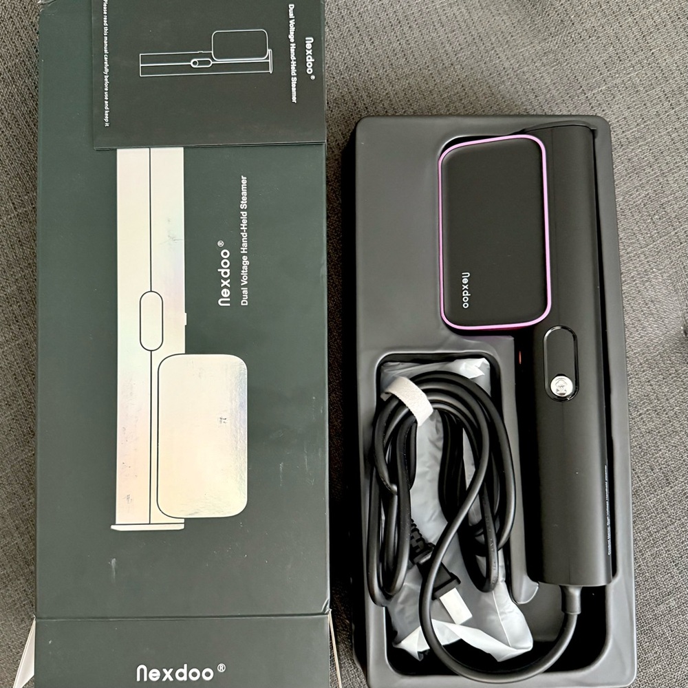 Dual voltage hand held steamer